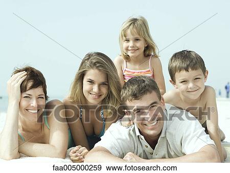 Family lying on beach, smiling, portrait View Large Photo Image Stock Photo - Family lying on beach, smiling, portrait. Fotosearch