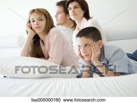 Family sitting on sofa together View Large Photo Image Stock Image - Family sitting on sofa together. Fotosearch