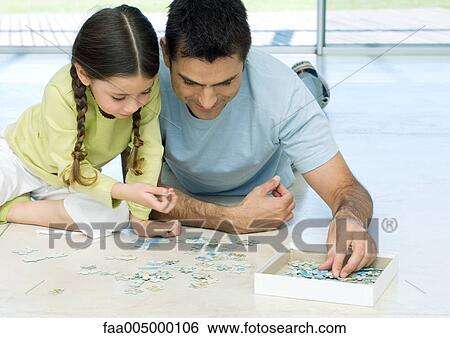 Father and daughter putting puzzle together View Large Photo Image Stock Photograph - Father and daughter putting puzzle together. Fotosearch