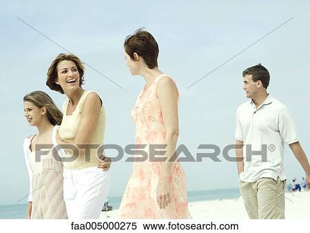 Stock Photography - Friends walking on the beach. Fotosearch