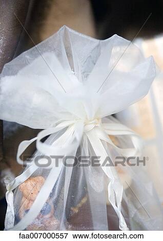 Stock Photo - Gift enclosed in translucent fabric. Fotosearch