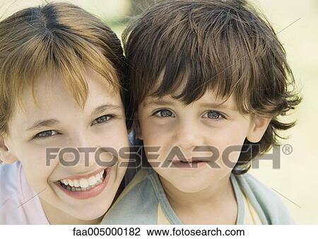 Girl and boy smiling, portrait View Large Photo Image Stock Image - Girl and boy smiling, portrait. Fotosearch