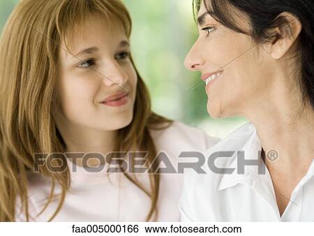 Girl and grandmother smiling at each other View Large Photo Image Stock Photograph - Girl and grandmother smiling at each other. Fotosearch