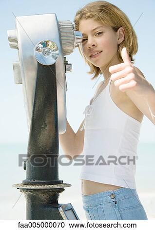 Girl giving thumbs up from behind pay binoculars View Large Photo Image Stock Image - Girl giving thumbs up from behind pay binoculars. Fotosearch