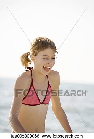 Girl laughing on beach View Large Photo Image Stock Photograph - Girl laughing on beach. Fotosearch