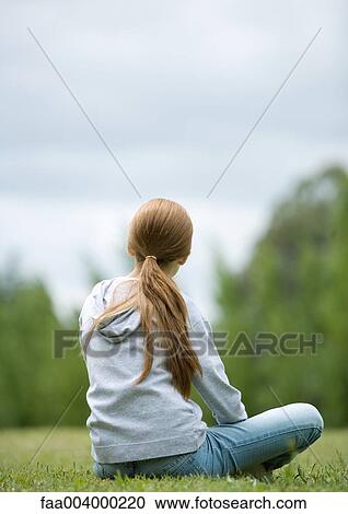 Girl sitting on grass, rear view View Large Photo Image Stock Image - Girl sitting on grass, rear view. Fotosearch