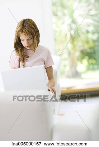 Girl using laptop View Large Photo Image Stock Photo - Girl using laptop. Fotosearch