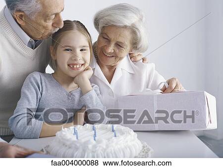 Girl with grandparents on her birthday View Large Photo Image Stock Photo - Girl with grandparents on her birthday. Fotosearch