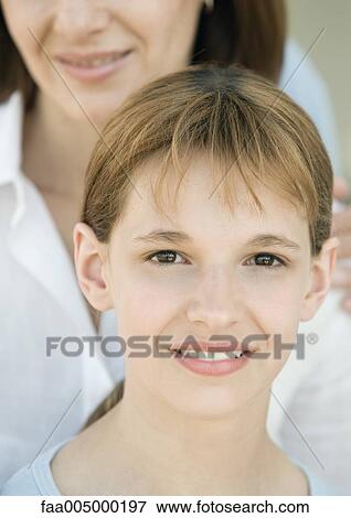 Stock Photo - Girl with mother in background, portrait. Fotosearch