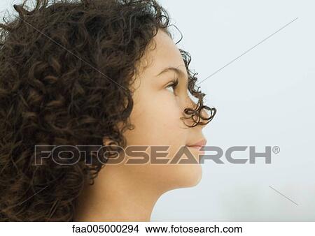 Girl with strand of hair in front of face, side view View Large Photo Image Picture - Girl with strand of hair in front of face, side view. Fotosearch