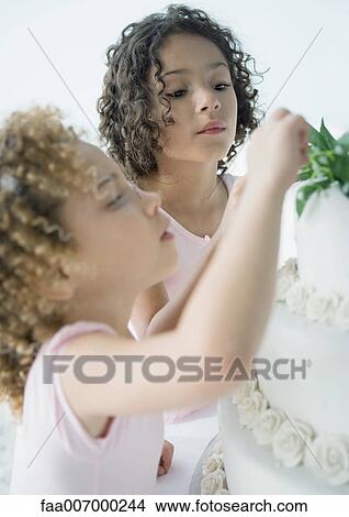 Girls looking at wedding cake View Large Photo Image Picture - Girls looking at wedding cake. Fotosearch