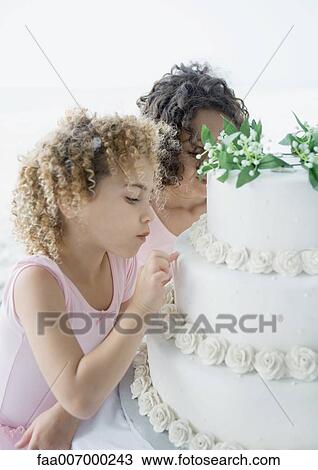 Girls looking at wedding cake View Large Photo Image Stock Image - Girls looking at wedding cake. Fotosearch
