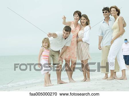 Group at the beach, pointing and looking toward distance View Large Photo Image Stock Image - Group at the beach, pointing and looking toward distance. Fotosearch