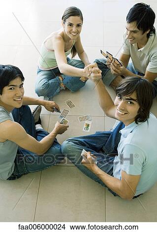 Group of young adult friends playing cards View Large Photo Image Picture - Group of young adult friends playing cards. Fotosearch