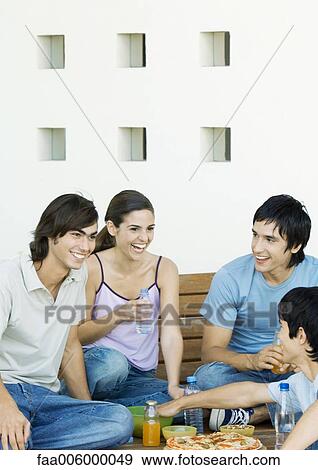 Group of young adult friends sharing meal View Large Photo Image Stock Photo - Group of young adult friends sharing meal. Fotosearch