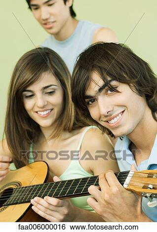 Group of young adult friends with guitar View Large Photo Image Stock Photograph - Group of young adult friends with guitar. Fotosearch