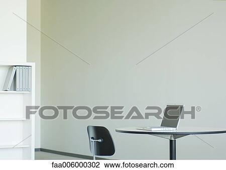 Laptop on table in office space View Large Photo Image Stock Image - Laptop on table in office space. Fotosearch