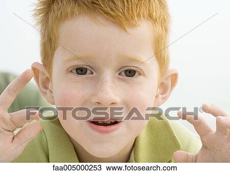 Little boy making face and holding up hands, portrait View Large Photo Image Stock Image - Little boy making face and holding up hands, portrait. Fotosearch