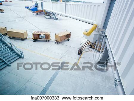 Luggage containers on airport tarmac View Large Photo Image Stock Image - Luggage containers on airport tarmac. Fotosearch