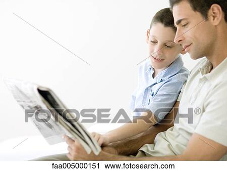 Stock Image - Man and son reading newspaper together. Fotosearch