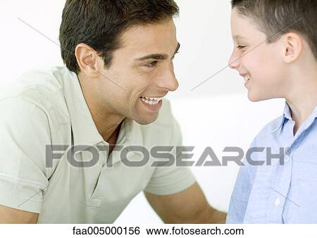 Stock Photograph - Man and son smiling at each other. Fotosearch