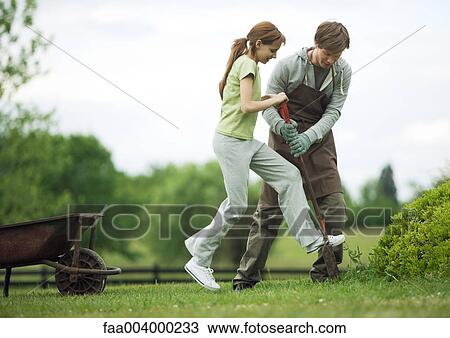 Man helping girl dig in yard View Large Photo Image Stock Image - Man helping girl dig in yard. Fotosearch