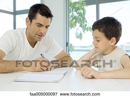 Man helping son with homework View Large Photo Image Stock Photo - Man helping son with homework. Fotosearch