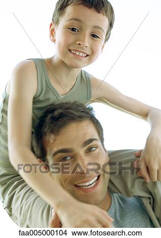 Man holding son on shoulders View Large Photo Image Picture - Man holding son on shoulders. Fotosearch