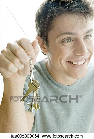Man holding up keys View Large Photo Image Picture - Man holding up keys. Fotosearch