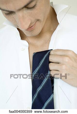 Man holding up tie View Large Photo Image Stock Photo - Man holding up tie. Fotosearch