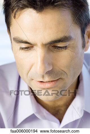 Man looking down, close-up of head, portrait View Large Photo Image Picture - Man looking down, close-up of head, portrait. Fotosearch