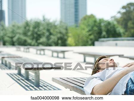 Man napping on bench in city park View Large Photo Image Stock Photo - Man napping on bench in city park. Fotosearch