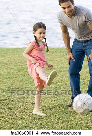 Man playing soccer with daughter View Large Photo Image Picture - Man playing soccer with daughter. Fotosearch