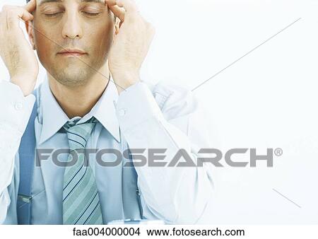 Man rubbing temples with eyes closed View Large Photo Image Picture - Man rubbing temples with eyes closed. Fotosearch