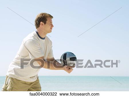 Man serving volleyball on beach View Large Photo Image Stock Image - Man serving volleyball on beach. Fotosearch