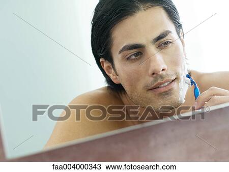 Man shaving face in mirror View Large Photo Image Stock Image - Man shaving face in mirror. Fotosearch