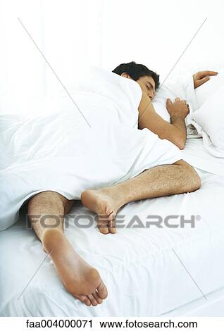 Man sleeping on stomach in bed View Large Photo Image Stock Image - Man sleeping on stomach in bed. Fotosearch