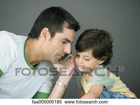 Man using cell phone, leaning toward son View Large Photo Image Stock Photography - Man using cell phone, leaning toward son. Fotosearch