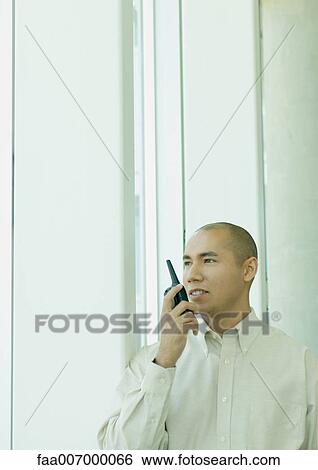 Stock Photograph - Man using walkie-talkie. Fotosearch