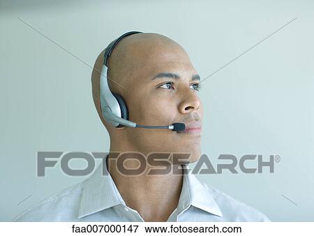 Man wearing headset, portrait View Large Photo Image Stock Photo - Man wearing headset, portrait. Fotosearch
