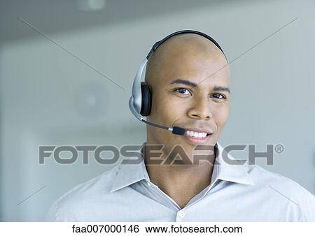 Man wearing headset, portrait View Large Photo Image Stock Photograph - Man wearing headset, portrait. Fotosearch