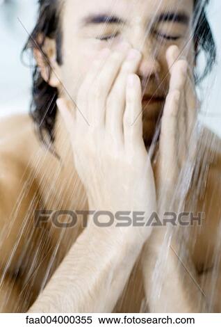 Man with eyes closed in shower View Large Photo Image Stock Photography - Man with eyes closed in shower. Fotosearch