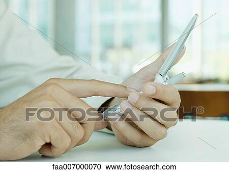 Man's hands dialing number on cell-phone View Large Photo Image Stock Image - Man's hands dialing number on cell-phone. Fotosearch