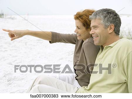 Mature couple sitting on beach, side view View Large Photo Image Stock Image - Mature couple sitting on beach, side view. Fotosearch