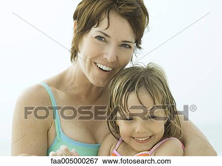 Stock Photo - Mother and daughter wearing swimsuits, portrait. Fotosearch
