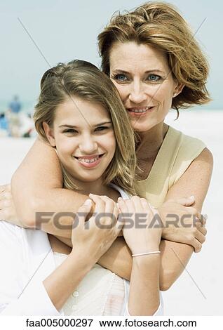 Mother with arms around teenage daughter, portrait View Large Photo Image Stock Photo - Mother with arms around teenage daughter, portrait. Fotosearch