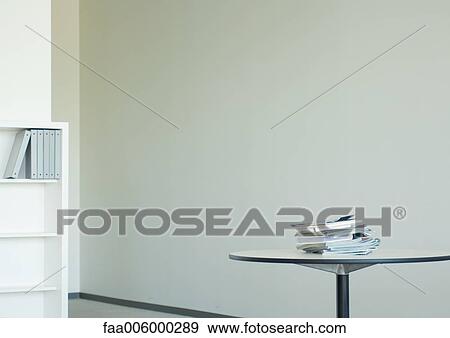 Office space, stack of catalogs on table View Large Photo Image Stock Photo - Office space, stack of catalogs on table. Fotosearch