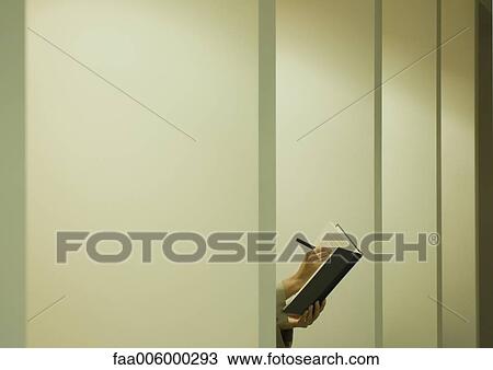 Person behind partition, writing in agenda View Large Photo Image Stock Image - Person behind partition, writing in agenda. Fotosearch