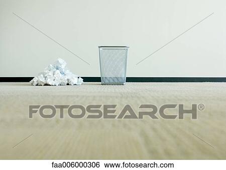 Stock Photograph - Pile of crumpled paper next to empty wastebasket. Fotosearch