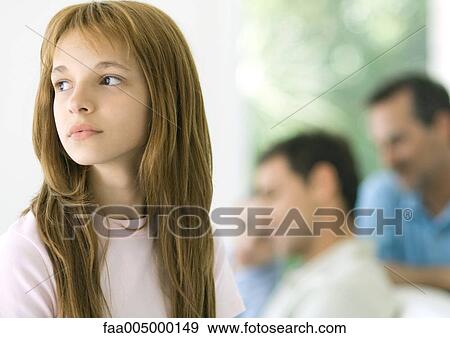 Preteen girl, family in background View Large Photo Image Stock Photo - Preteen girl, family in background. Fotosearch